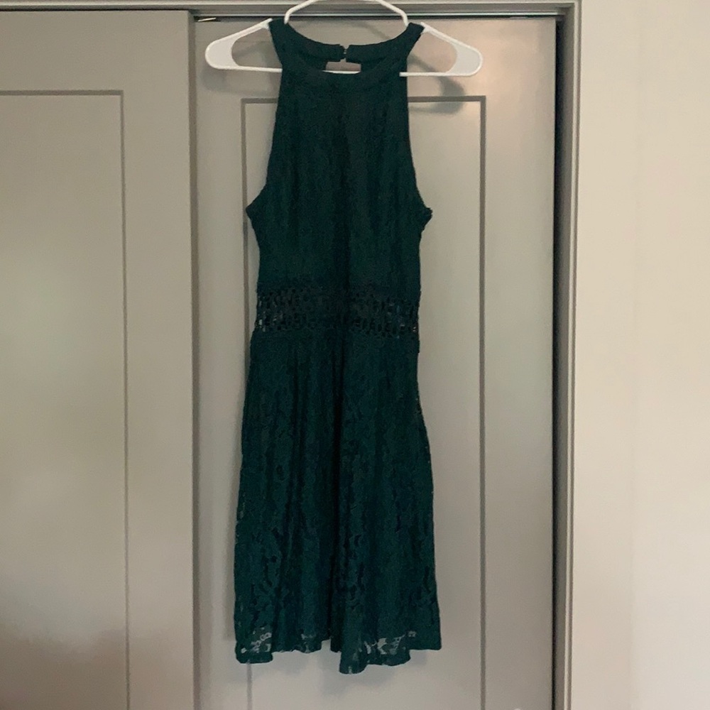 Green halter dress with lace detail.